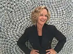 Artist Susan Sensemann, in 2018, in front of one of her paintings.