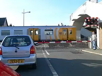 A level crossing at Hoylake, Merseyside, England, with a train passing