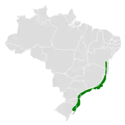 Map of Brazil with dark green shading indicating the species occurs along the southeastern coast of the country