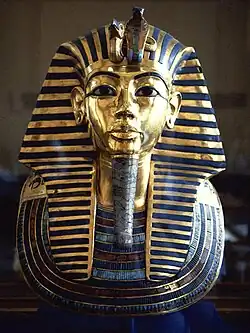 Tutankhamun's mask - King Tutankhamun, son of Akhenaten, returned to the former capitol and restored the cult of Amun to its former influence; although he died young and was not considered significant in his own time, the 1922 discovery of his KV62 intact tomb by Howard Carter, made him relevant as a symbol of ancient Egypt to the modern world