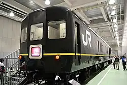 Former Twilight Express generator van KaNi 24-12 and lounge car OHa 25-551 in the Main Hall at the Kyoto Railway Museum in May 2016