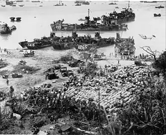 USS LST-1000 and beach with cargo