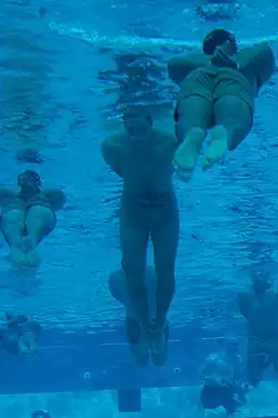 First Phase Trainees have their arms and legs tied as a part of "drown proofing" training.