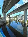View of creek under Metrorail pylons from NW 11th Street bridge (view northwest)