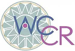 Turquoise wheel shape with "WCCR" written in blue and pink text