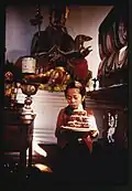 Young girl, Kimu, carrying a birthday cake through the Lachung Monastery, Sikkim February 1969.