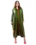 Model in green Moroccan djellaba edited for online product display