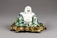 Chinese porcelain figure of Budai with European ormolu stand. Qing dynasty, 1720–1730.