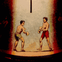 An image from a Phenakistoscope, a primitive animation device, showing two athletes boxing