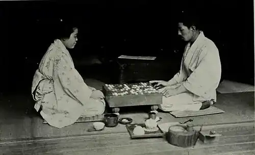two japanese people playing go.