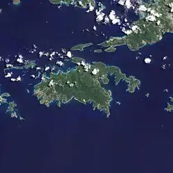 Satellite photograph of one of the islands in the archipelago: green islands in the blue sea with dots of white cloud.