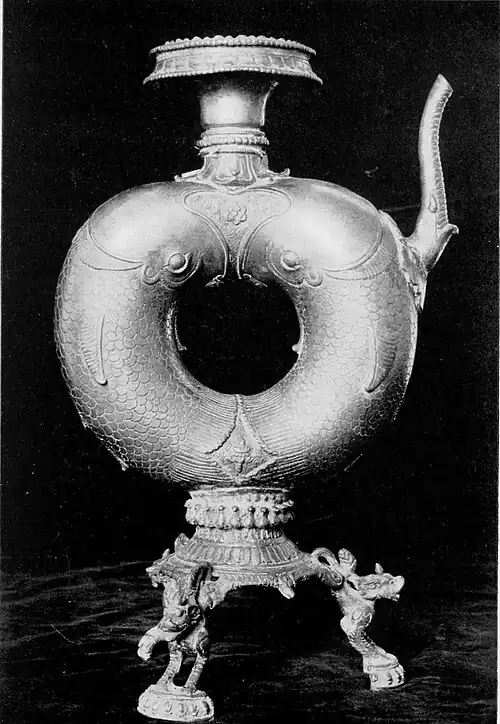 Black and white photograph of a brass temple utensil from Patan.