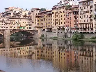 Buildings reflected in river. Florence, Italy